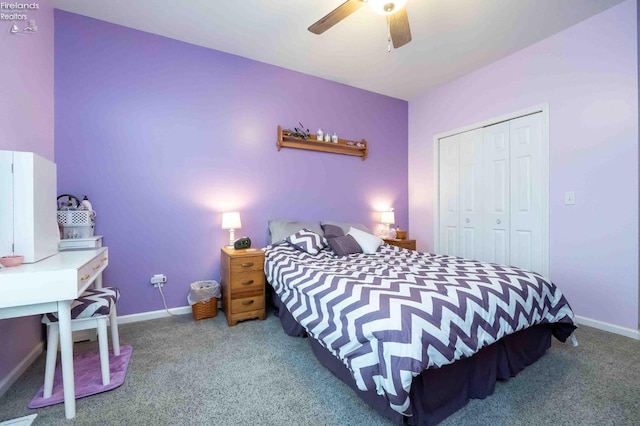 carpeted bedroom featuring ceiling fan, a closet, and baseboards