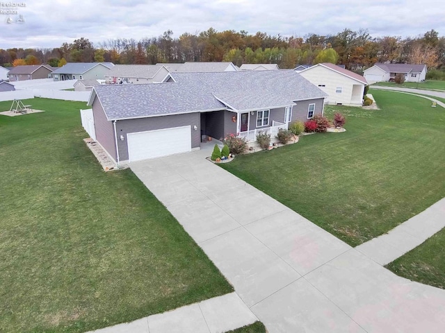 ranch-style house featuring driveway, a garage, roof with shingles, a front lawn, and a porch