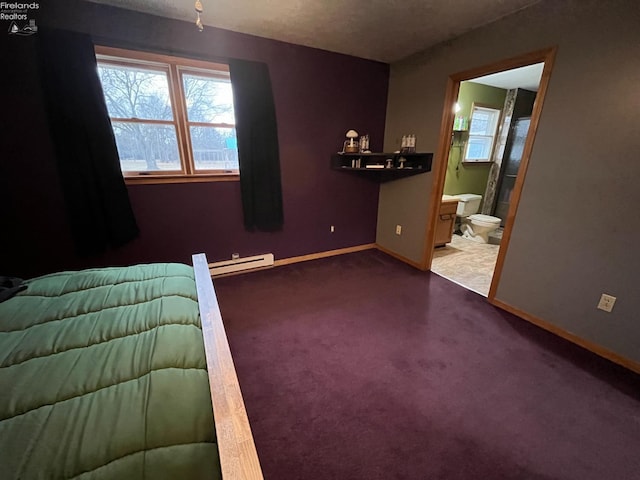 unfurnished bedroom with dark colored carpet, multiple windows, ensuite bath, and baseboards