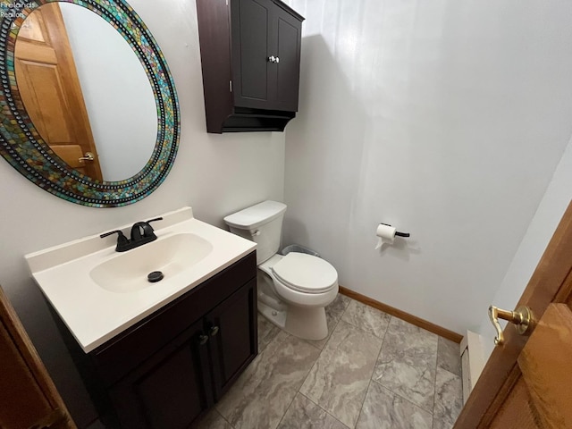 half bath featuring toilet, baseboards, and vanity