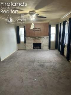 unfurnished living room with ceiling fan, ornamental molding, and a fireplace