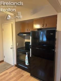 kitchen with black appliances, light wood-style flooring, and under cabinet range hood