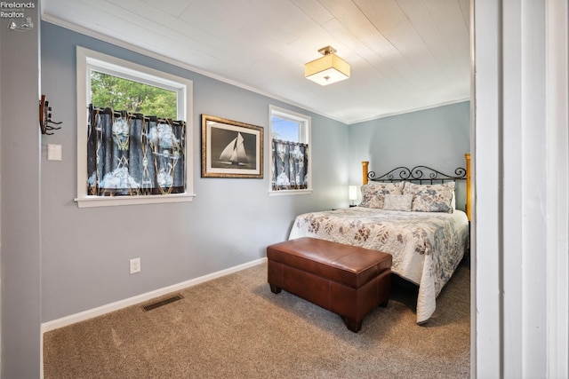 bedroom featuring visible vents, crown molding, baseboards, and multiple windows