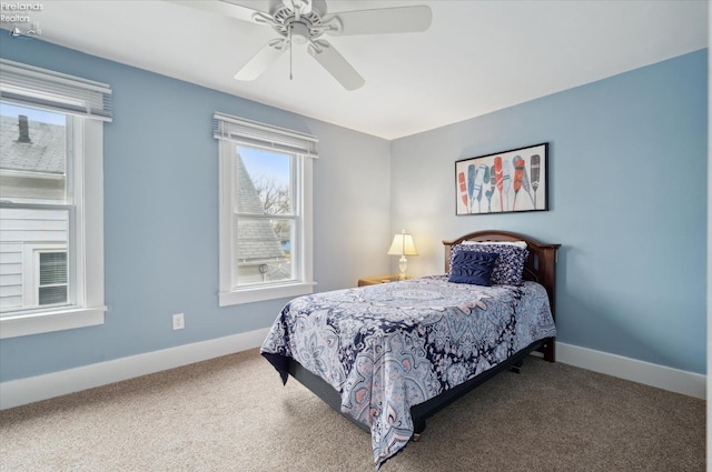 bedroom with carpet floors, multiple windows, and baseboards