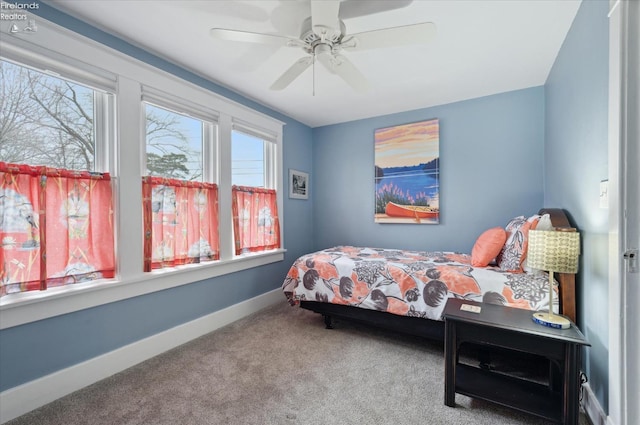 carpeted bedroom featuring ceiling fan and baseboards