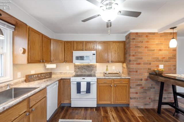 kitchen with white appliances, dark wood finished floors, a ceiling fan, brown cabinetry, and a sink