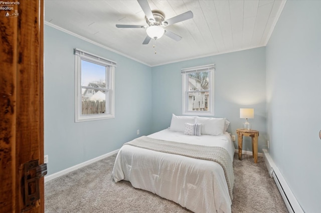 bedroom featuring a baseboard heating unit, carpet flooring, baseboards, and multiple windows