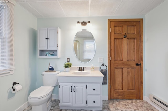 bathroom featuring baseboards, toilet, vanity, and baseboard heating