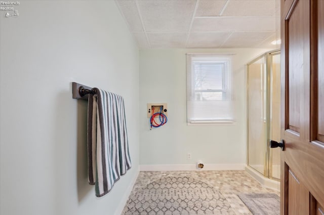 washroom with laundry area, baseboards, washer hookup, and tile patterned flooring