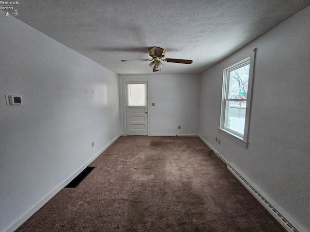 empty room with plenty of natural light, carpet, visible vents, and baseboards