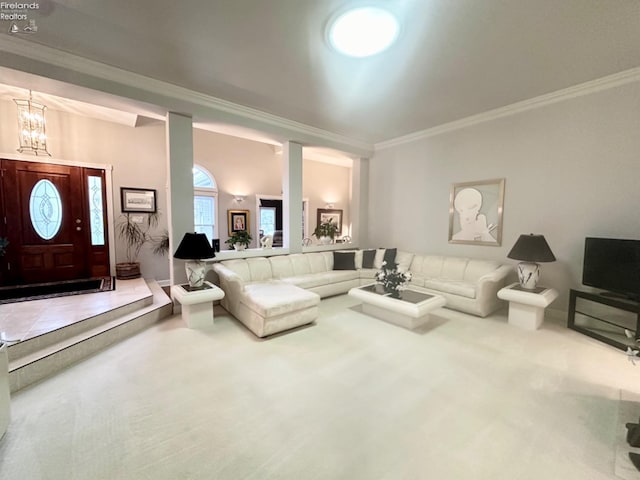 carpeted living room featuring ornamental molding and an inviting chandelier