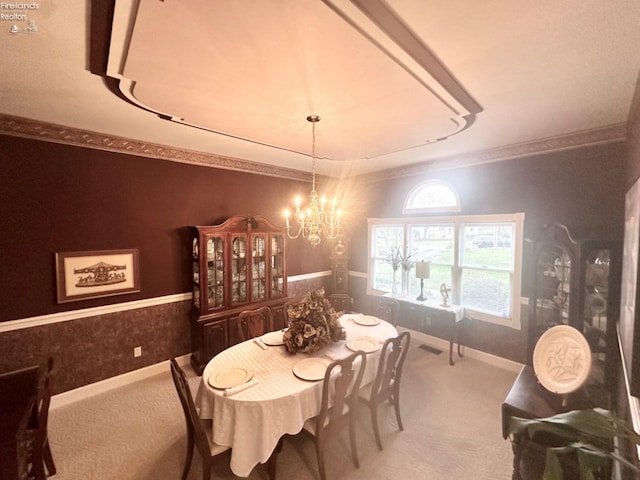 dining area with wallpapered walls, baseboards, carpet, crown molding, and a chandelier