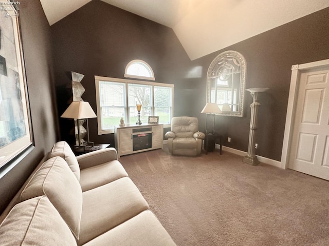 carpeted living area with high vaulted ceiling and baseboards