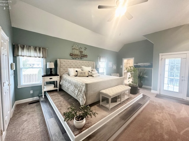 carpeted bedroom with ceiling fan, baseboards, vaulted ceiling, and access to outside