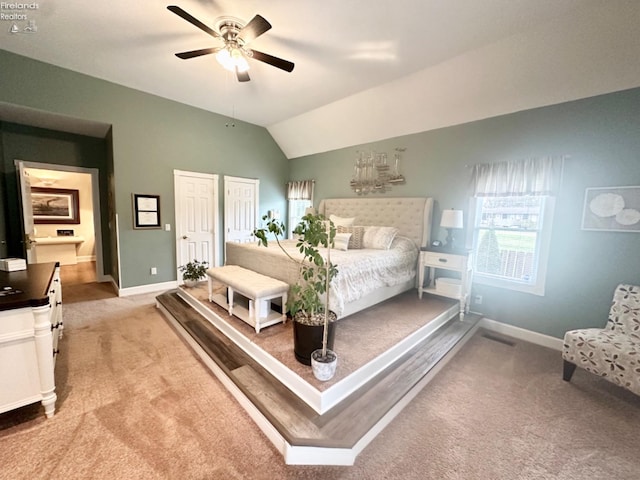 carpeted bedroom featuring a ceiling fan, lofted ceiling, and baseboards