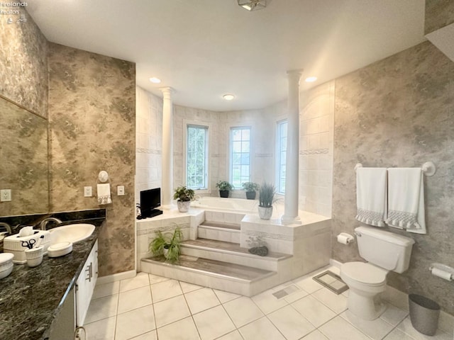 full bathroom with tile patterned flooring, toilet, a sink, a bath, and ornate columns