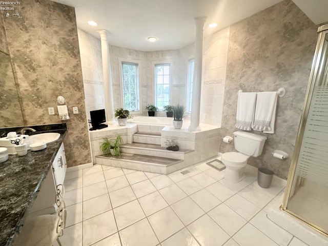 full bath featuring toilet, vanity, tile patterned floors, a stall shower, and decorative columns