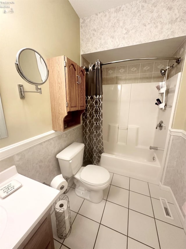 full bathroom featuring shower / bath combo, visible vents, toilet, tile patterned floors, and vanity