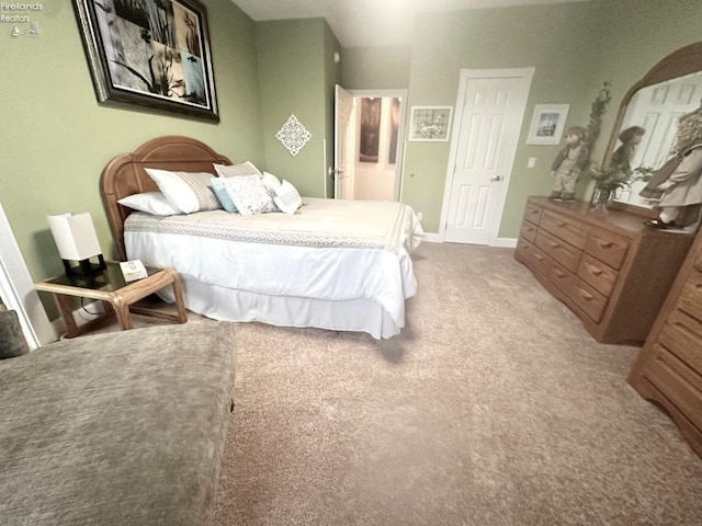 bedroom featuring carpet and baseboards