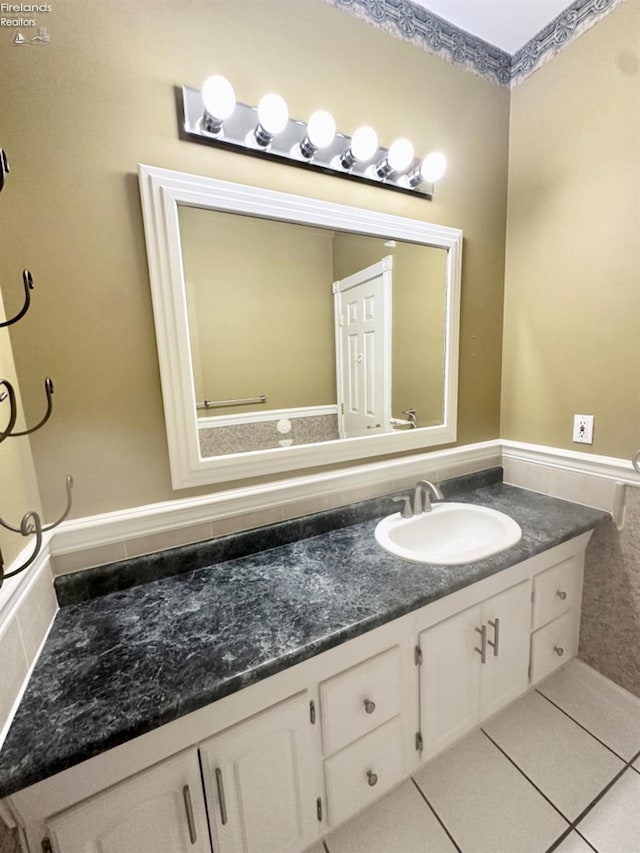 bathroom featuring a wainscoted wall, vanity, and tile patterned floors