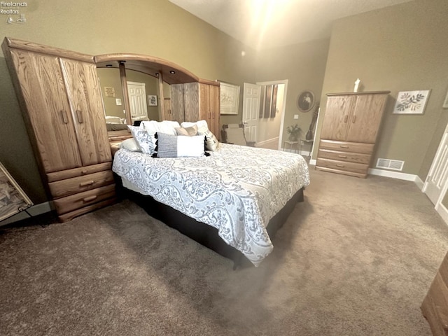 bedroom featuring carpet floors, arched walkways, visible vents, high vaulted ceiling, and baseboards