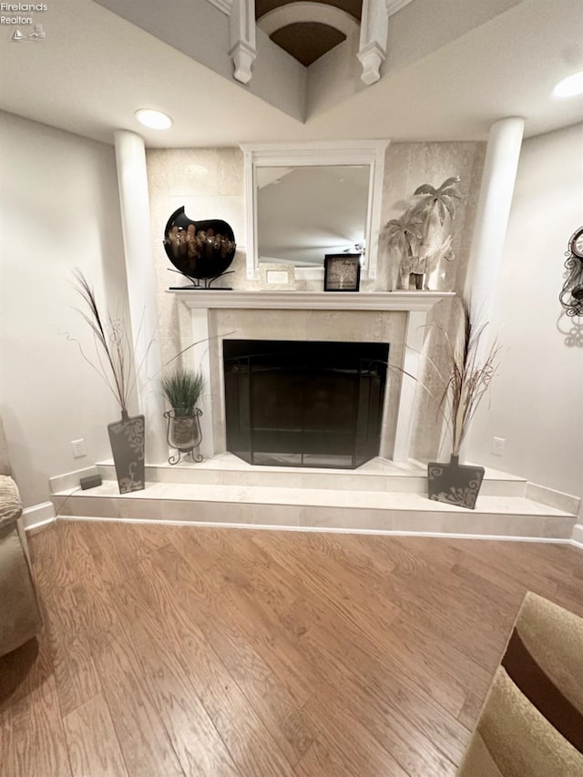 details with recessed lighting, a fireplace, baseboards, and wood finished floors