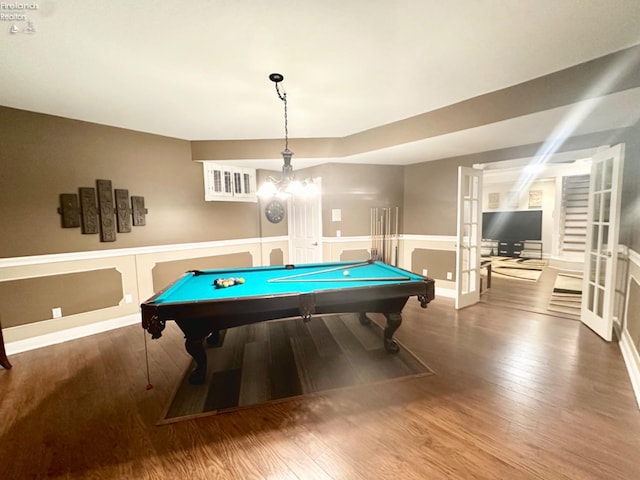 rec room with billiards, visible vents, a wainscoted wall, wood finished floors, and french doors