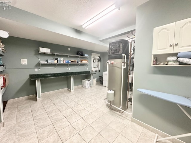 interior space featuring a textured ceiling, baseboards, and tile patterned floors