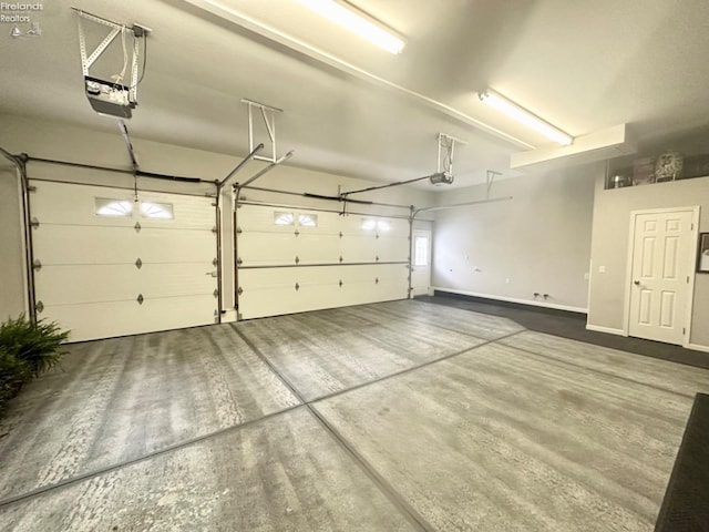 garage featuring baseboards and a garage door opener