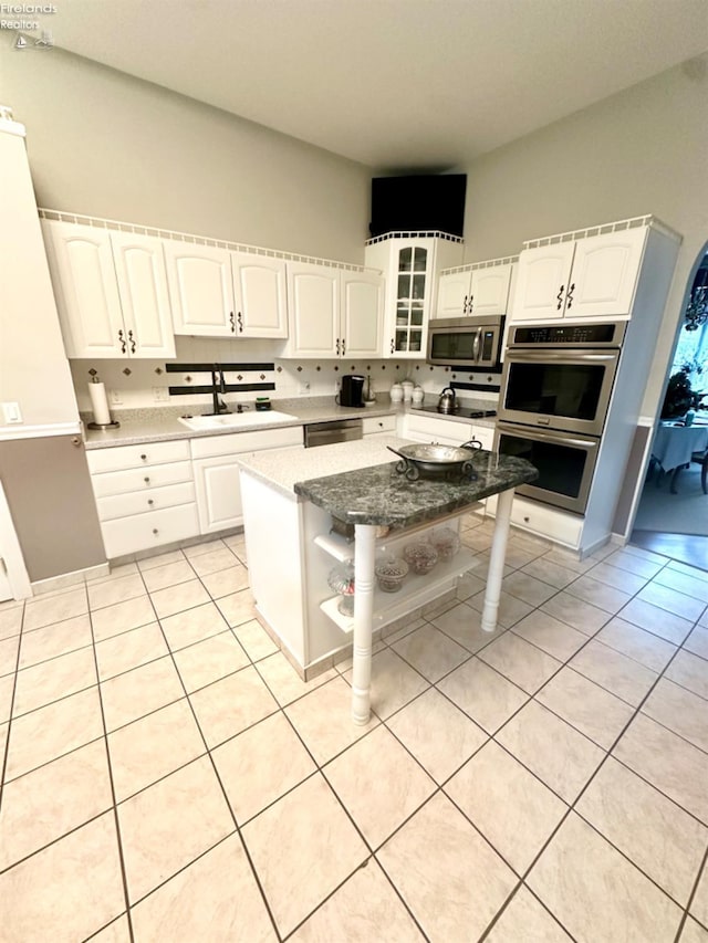 kitchen featuring white cabinets, stainless steel appliances, and a sink