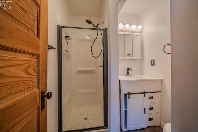 bathroom featuring a stall shower and vanity