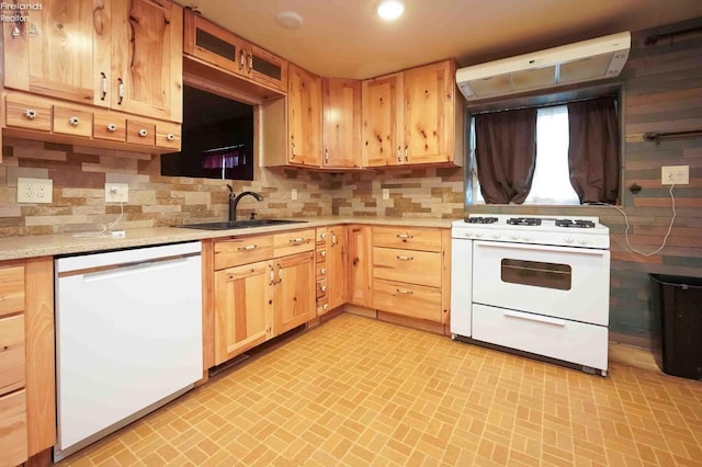 kitchen with light brown cabinets, under cabinet range hood, white appliances, a sink, and decorative backsplash