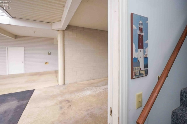 interior space featuring stairs and unfinished concrete floors