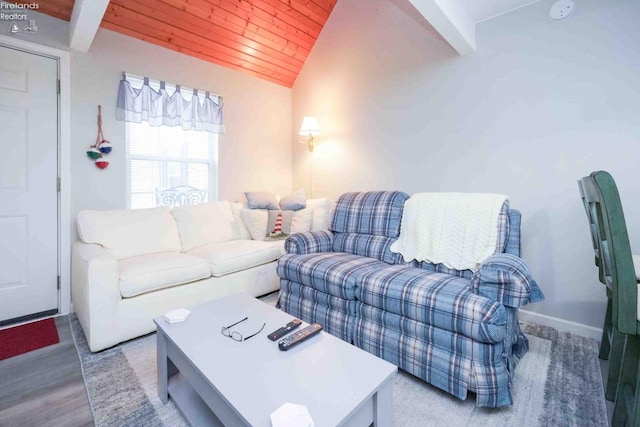 living area featuring wooden ceiling, baseboards, and vaulted ceiling