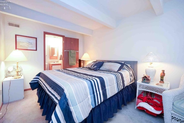 bedroom featuring carpet floors, connected bathroom, visible vents, and beam ceiling