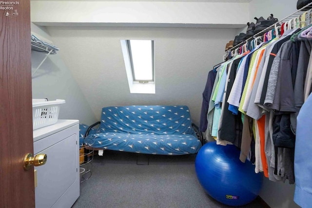 spacious closet with a skylight, washer / clothes dryer, and carpet flooring