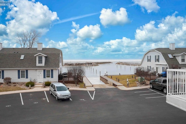 uncovered parking lot with a water view