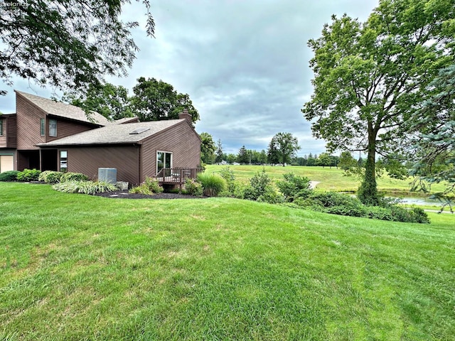 view of yard with a garage and a wooden deck