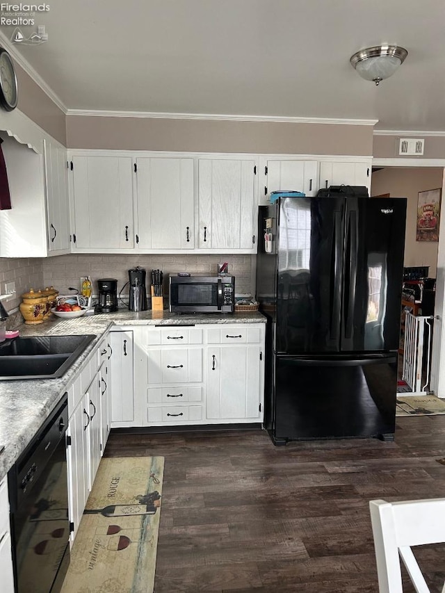 kitchen featuring white cabinets, black appliances, dark wood finished floors, and a sink