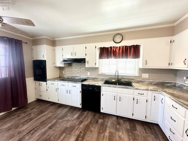 kitchen with white cabinets, crown molding, a sink, under cabinet range hood, and black appliances