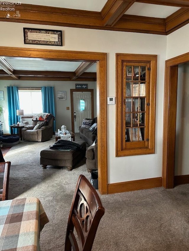 hallway with carpet, beam ceiling, crown molding, and baseboards