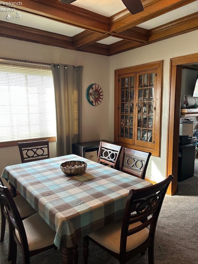 carpeted dining space featuring coffered ceiling and beam ceiling