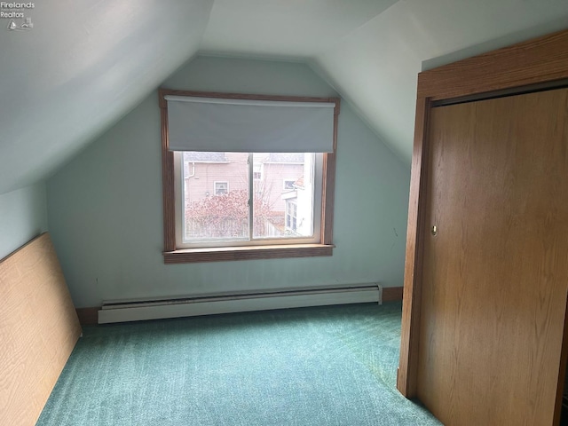 additional living space featuring carpet, a baseboard radiator, and vaulted ceiling