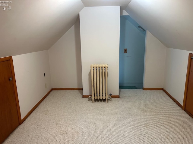 bonus room with carpet floors, baseboards, vaulted ceiling, and radiator heating unit