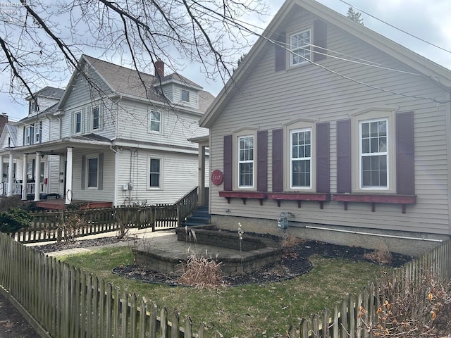 view of property exterior featuring entry steps and a fenced backyard