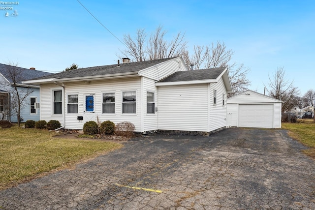 view of front of house with a garage, a front lawn, driveway, and an outdoor structure