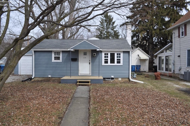 bungalow with central air condition unit and a chimney