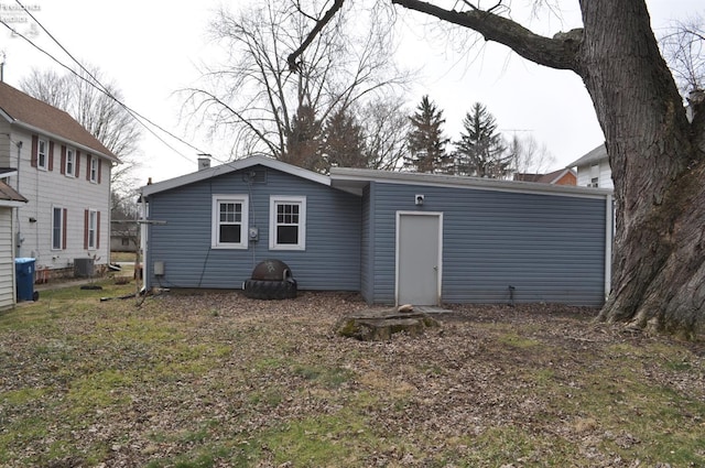 rear view of property with central AC