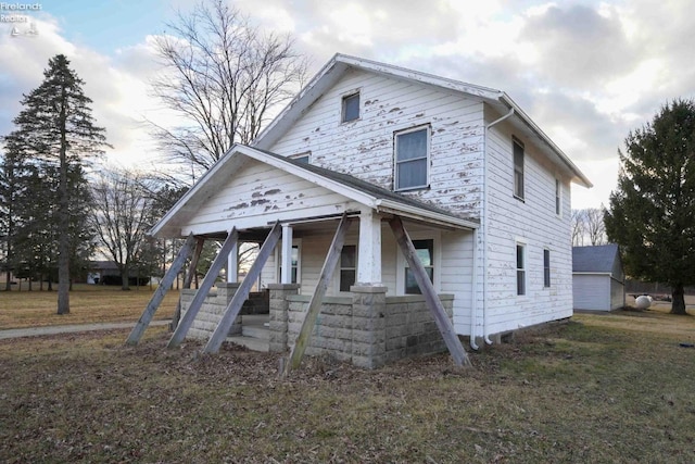 view of front of house featuring covered porch and a front lawn