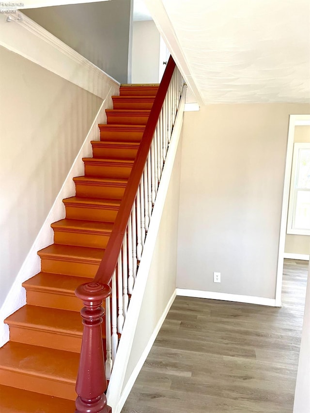 stairs with baseboards and wood finished floors